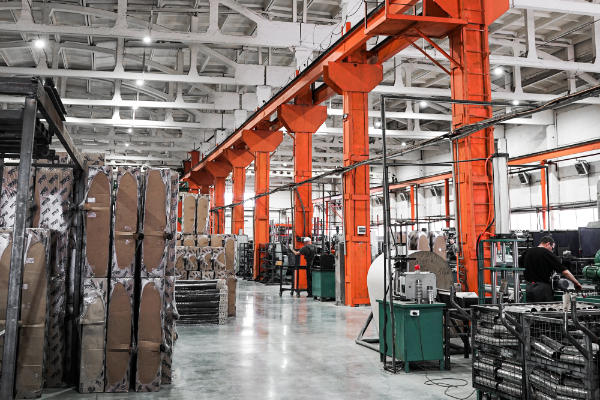 Inside an industrial cannabis building with pallets on the floor and machinery going