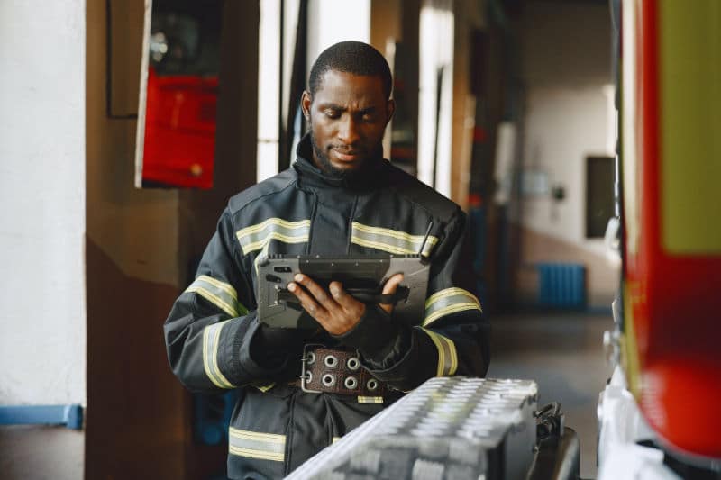 Fireman looking at safety procedures on a tablet